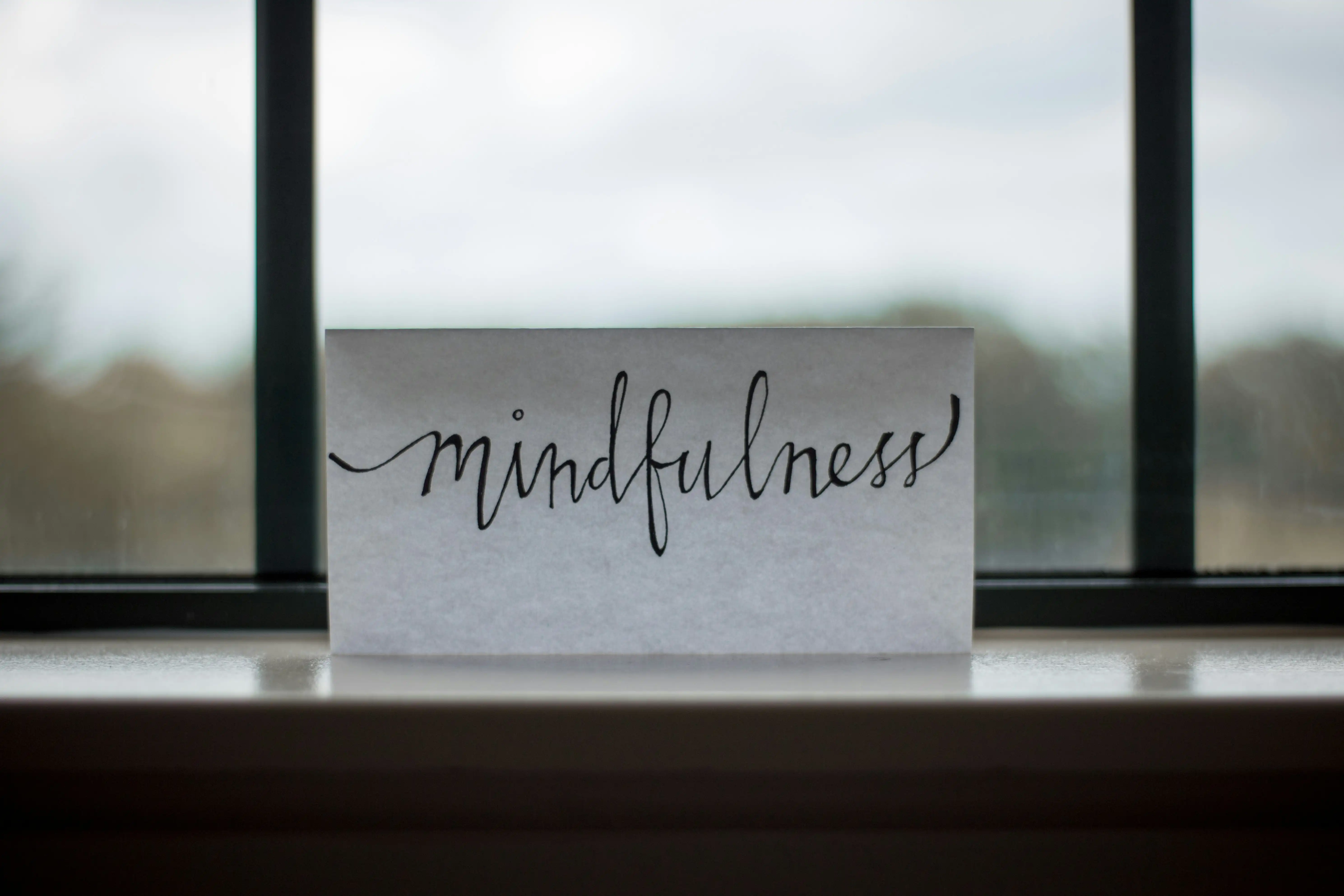 Person meditating with a serene background, illustrating 5-minute mindfulness